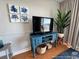 Living room with a TV, decorative art, a plant, and a vintage blue console table with a basket at 5511 N Ocean Blvd. # 1006, Myrtle Beach, SC 29577