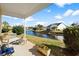 Relaxing back porch features a bench and overlooks a serene pond, lush landscaping, and charming neighborhood at 5719 Whistling Duck Dr., North Myrtle Beach, SC 29582