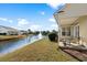 Tranquil back porch with seating offers picturesque views of the pond, fountain, and well-manicured lawn at 5719 Whistling Duck Dr., North Myrtle Beach, SC 29582