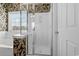 Bathroom featuring tub, glass shower, and window with decorative leaf-patterned wallpaper at 5719 Whistling Duck Dr., North Myrtle Beach, SC 29582