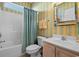 Colorful bathroom with tub and shower combination, cabinet sink, and decorative mirror at 5719 Whistling Duck Dr., North Myrtle Beach, SC 29582