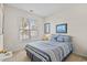 Bright bedroom with striped bedding, carpet flooring, and a sunny window view at 5719 Whistling Duck Dr., North Myrtle Beach, SC 29582