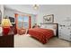 Inviting bedroom with a red patterned bedspread, TV, decorative chair, and chest of drawers, creating a cozy retreat at 5719 Whistling Duck Dr., North Myrtle Beach, SC 29582