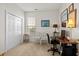 Cozy bedroom/office space featuring neutral walls, closet, desk, and bright natural light at 5719 Whistling Duck Dr., North Myrtle Beach, SC 29582