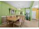 Dining room featuring a large table, chandelier, and green walls at 5719 Whistling Duck Dr., North Myrtle Beach, SC 29582