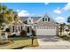 Charming one-story home with brick facade, two-car garage, and well-manicured landscaping at 5719 Whistling Duck Dr., North Myrtle Beach, SC 29582