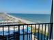 Balcony view of the ocean and coastline, with a pool and a cityscape visible at 5907 S Kings Hwy. # 1409, Myrtle Beach, SC 29575