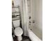 Clean bathroom featuring a toilet, bathtub with shower, and convenient storage shelving at 5907 S Kings Hwy. # 1409, Myrtle Beach, SC 29575