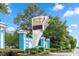 A sign to the Myrtle Beach Resort with blue columns and mature landscaping under a blue sky at 5907 S Kings Hwy. # 1409, Myrtle Beach, SC 29575