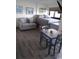 Open living area with a sleeper sofa, queen bed, a table with chairs, and hardwood floors at 5907 S Kings Hwy. # 1409, Myrtle Beach, SC 29575