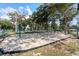 Open playground area with swings, surrounded by mature trees and a soft sand surface at 5907 S Kings Hwy. # 1409, Myrtle Beach, SC 29575