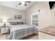 Cozy bedroom featuring a ceiling fan, beach-themed artwork, and a large window at 6001-1723 South Kings Hwy., Myrtle Beach, SC 29575