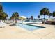 Inviting outdoor pool area with a mushroom fountain, surrounded by lounge chairs and tropical palm trees at 6001-1723 South Kings Hwy., Myrtle Beach, SC 29575