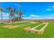 Inviting recreation area with a bocce ball court, picnic benches, and palm trees under a clear blue sky at 6001-1723 South Kings Hwy., Myrtle Beach, SC 29575