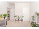 Bright living room featuring neutral walls, carpet, and a decorative shelf full of plants at 616 Choctaw Dr., Conway, SC 29526