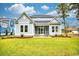 Beautiful home featuring a covered porch and a lush green lawn at 641 Waterbridge Blvd., Myrtle Beach, SC 29579