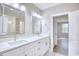Elegant bathroom vanity with double sinks, marble countertop, and modern fixtures and a view of the shower at 641 Waterbridge Blvd., Myrtle Beach, SC 29579
