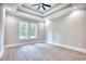 Bedroom with tray ceiling, recessed lighting, ceiling fan, and two windows for natural light at 641 Waterbridge Blvd., Myrtle Beach, SC 29579