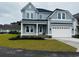 Charming two-story home with a well-manicured lawn, a two-car garage, and a covered front porch at 641 Waterbridge Blvd., Myrtle Beach, SC 29579