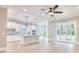 Open-concept living room with a modern kitchen island, hardwood floors, and sliding glass doors at 641 Waterbridge Blvd., Myrtle Beach, SC 29579