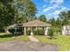 Charming single-story home featuring a well-maintained lawn, mature trees, and welcoming curb appeal at 6512 Laguna Point, Myrtle Beach, SC 29588