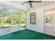 Inviting sunroom featuring a ceiling fan, vinyl siding and outdoor access to the backyard at 6512 Laguna Point, Myrtle Beach, SC 29588