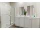 Bathroom features a glass-enclosed shower, dual sink vanity with white cabinets and chrome faucets at 692 Wallace Dr., Little River, SC 29566