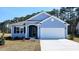 Charming single-story home featuring a two-car garage and classic blue siding at 746 Plumage Ct., Myrtle Beach, SC 29588