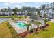 Gorgeous aerial view of the sparkling community pool, modern condos, and lush surroundings at 750 Charter Dr. # E-2, Longs, SC 29568