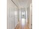 A bright hallway with hardwood floors, white doors, and a view to the outside at 750 Charter Dr. # E-2, Longs, SC 29568