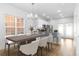 Bright dining room with hardwood floors, modern lighting, and bar seating at kitchen at 763 Moen Pl. # 763-A, Myrtle Beach, SC 29577