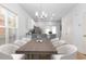 Bright dining room with hardwood floors, modern chandelier, and open to kitchen at 763 Moen Pl. # 763-A, Myrtle Beach, SC 29577