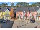 Two-story townhomes in vibrant colors with front porches and parking spaces in front of the buildings at 763 Moen Pl. # 763-A, Myrtle Beach, SC 29577