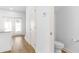 Hallway featuring neutral colors and an adjacent half bath with wood-look floors and white walls at 763 Moen Pl. # 763-A, Myrtle Beach, SC 29577