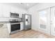 Clean kitchen showcasing stainless steel appliances, white cabinets and access to the outside at 763 Moen Pl. # 763-A, Myrtle Beach, SC 29577