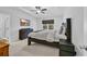 Bedroom with a tray ceiling, wood-frame bed, dresser, and a view of the trees outside at 820 Wild Leaf Loop, Conway, SC 29526