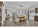 Bright, open dining room with modern light fixture, gray wood floors, and decor at 820 Wild Leaf Loop, Conway, SC 29526