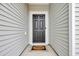 A black front door with a welcome mat at 820 Wild Leaf Loop, Conway, SC 29526