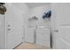 This well-lit laundry room features a washer, dryer, and shelving for supplies at 820 Wild Leaf Loop, Conway, SC 29526