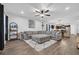 Spacious living room with a large gray sectional sofa, wood floors, and fan at 820 Wild Leaf Loop, Conway, SC 29526