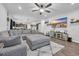 Open concept living room with a large gray sectional sofa, fan, and mounted TV at 820 Wild Leaf Loop, Conway, SC 29526