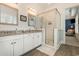 Bathroom featuring granite countertops, double sinks, and a glass-enclosed shower, illuminated by stylish lighting at 823 Howard Ave., Myrtle Beach, SC 29577