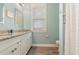 Bright bathroom features double sinks, granite counters, wood floors, and a window at 823 Howard Ave., Myrtle Beach, SC 29577