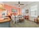 Inviting bedroom with colorful accent wall, wrought iron bed, and two windows at 823 Howard Ave., Myrtle Beach, SC 29577