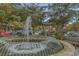 Beautiful fountain with water cascading into a pool surrounded by trees and greenery at 823 Howard Ave., Myrtle Beach, SC 29577