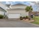 Two-car garage with low-maintenance landscaping features a palm tree at 823 Howard Ave., Myrtle Beach, SC 29577