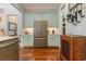 Modern kitchen featuring stainless steel refrigerator and appliances, complemented by custom cabinets and hardwood floors at 823 Howard Ave., Myrtle Beach, SC 29577