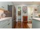 Modern kitchen with stainless steel refrigerator, white countertops, and easy access to both a pantry and laundry room at 823 Howard Ave., Myrtle Beach, SC 29577