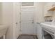 Functional laundry room with washer, dryer, sink, and cabinets, featuring neutral tones and ample space at 823 Howard Ave., Myrtle Beach, SC 29577