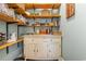 Charming pantry featuring open wooden shelves and a distressed white cabinet with countertop and bottom cupboards at 823 Howard Ave., Myrtle Beach, SC 29577